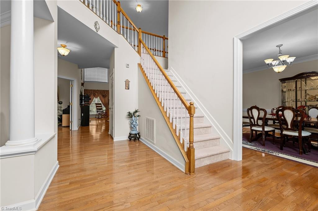 701 Number Ten Way Oak Ridge, NC 27310 - Photo 2 of 48 TWO WAY STAIRCASE FROM ENTRY OR KITCHEN