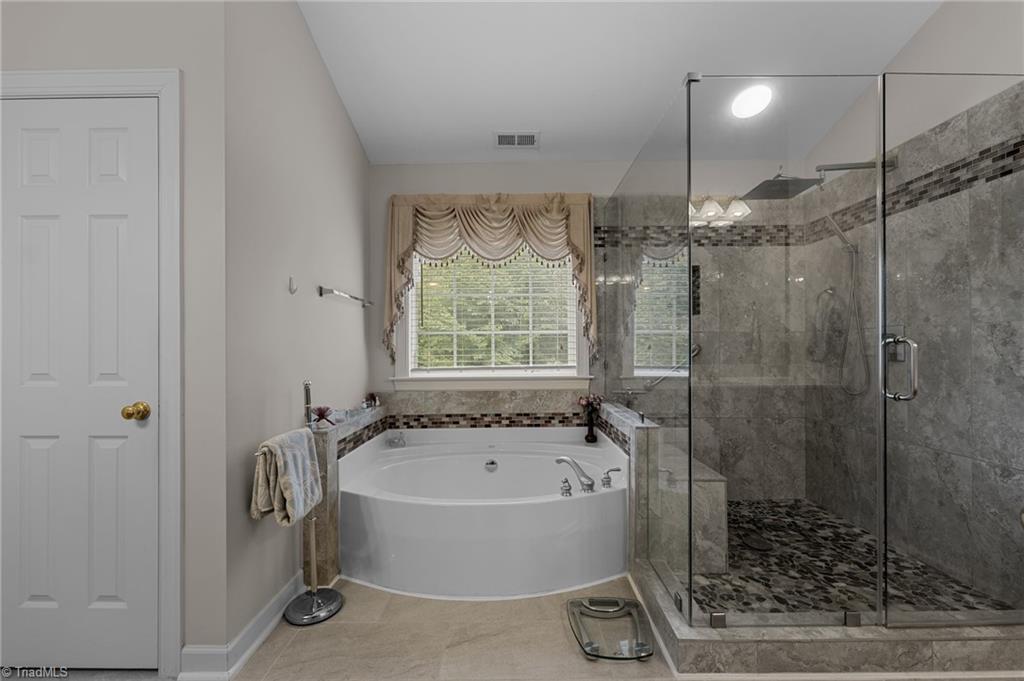 701 Number Ten Way Oak Ridge, NC 27310 - Photo 25 of 48 PRIMARY BATH INCLUDES A SOAKER TUB AND UPGRADED TILE WALK IN SHOWER