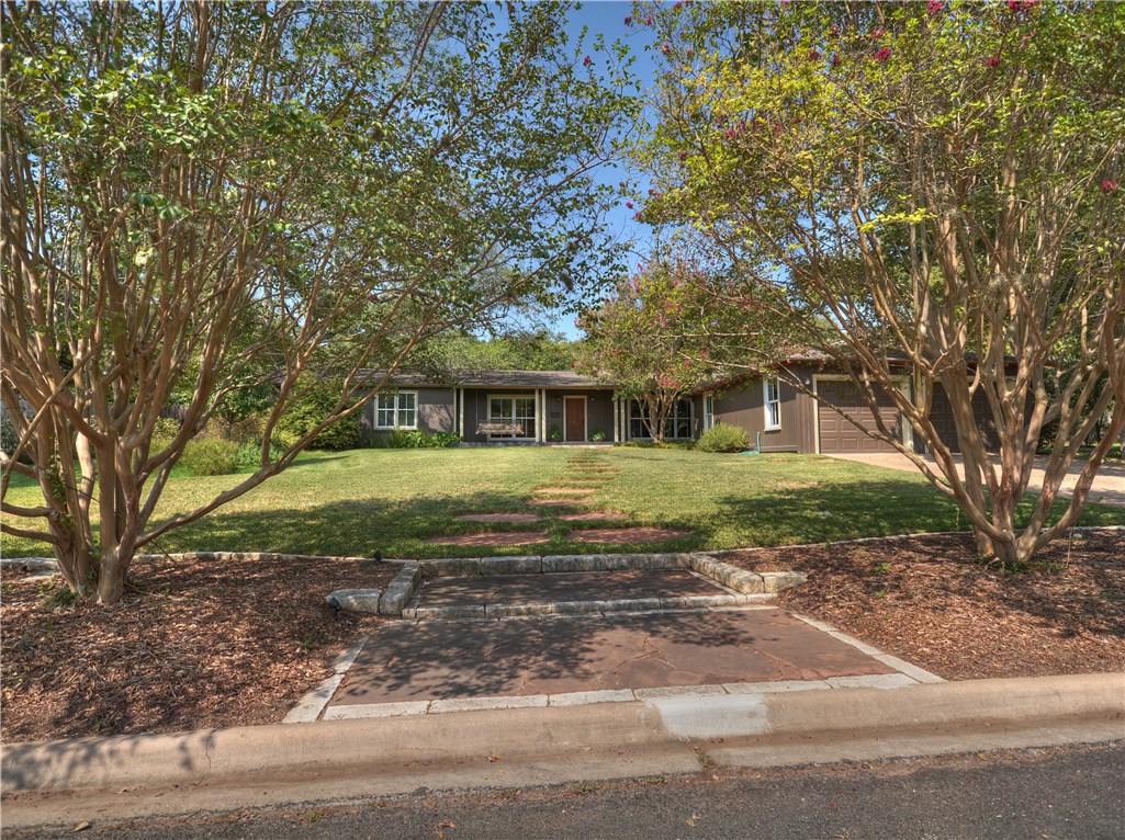 4702 Shadow Lane Austin, TX 78731 - Photo 1 of 1 a front view of a house with a yard