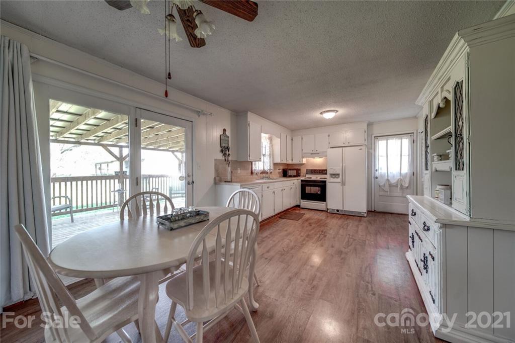 3007 Sikes Mill Road Monroe, NC 28110 - Photo 22 of 42 a view of kitchen and dining room with wooden floor