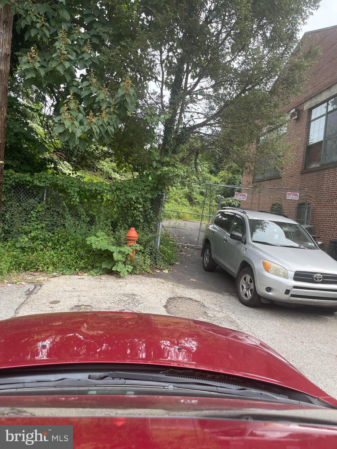 a view of a car parked on the side of a street