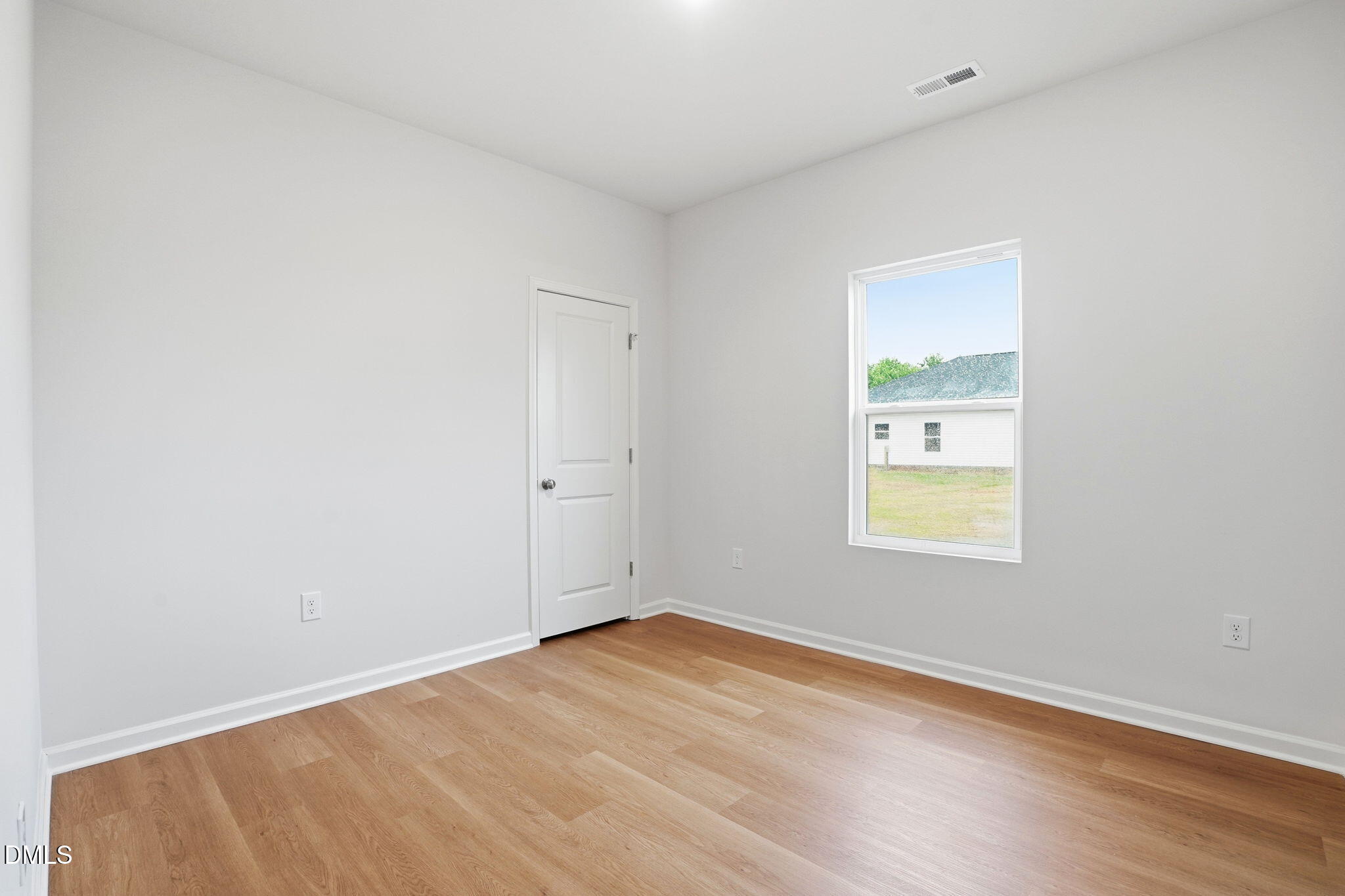 9019 Phoenix Court Spring Hope, NC 27882 - Photo 10 of 34 an empty room with a window and wooden floor