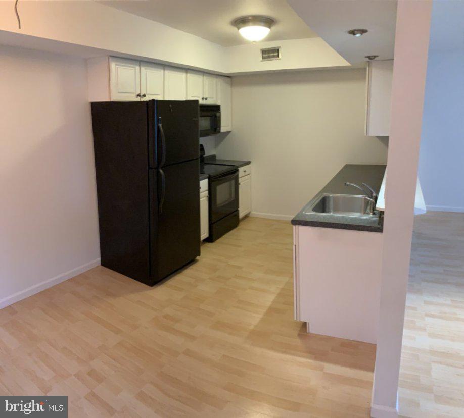 88 Sandra Road Voorhees, NJ 08043 - Photo 4 of 9 a kitchen with a refrigerator and a microwave