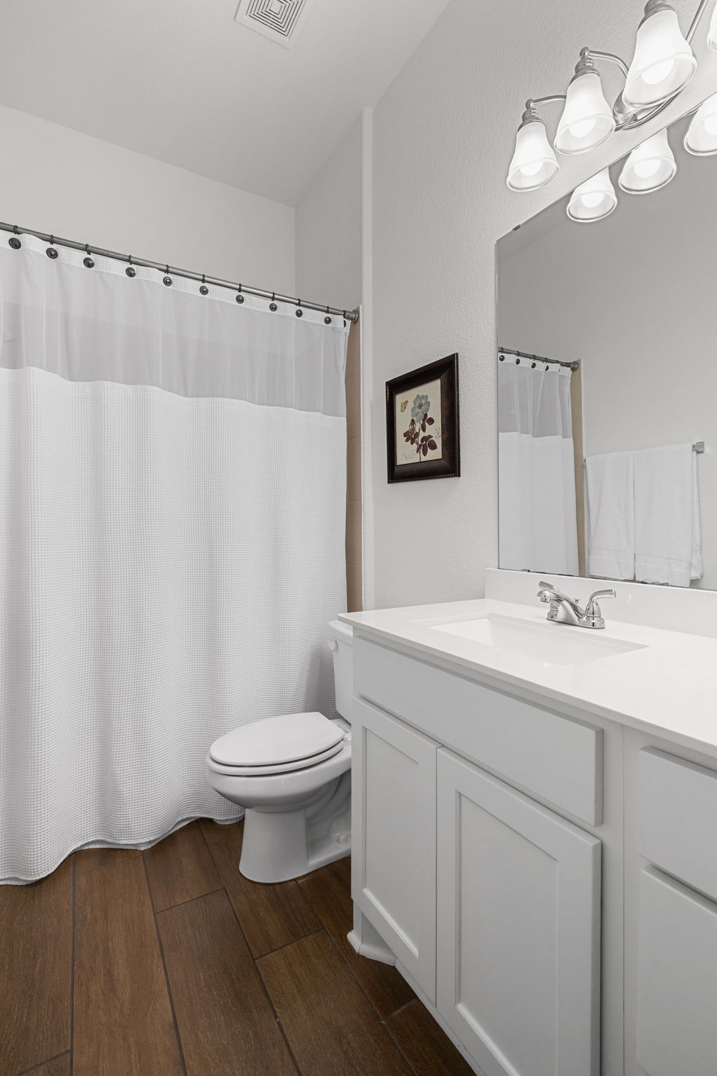 1908 Woolsey Way Leander, TX 78641 - Photo 20 of 36 A well-lit bathroom showcases a bright white vanity with ample storage.