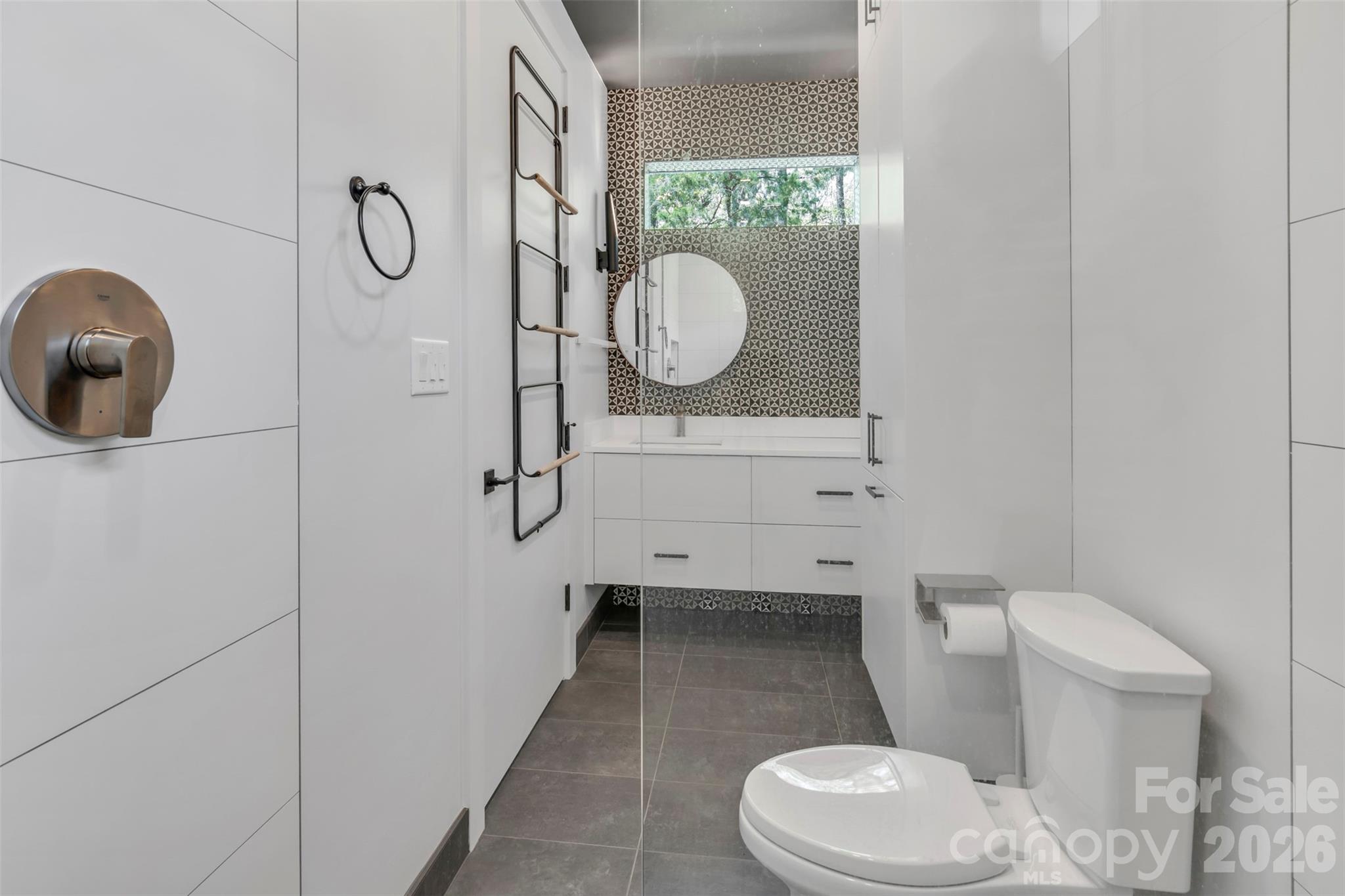 386 Squirrel Lane Clover, SC 29710 - Photo 29 of 45 a bathroom with a toilet a sink and mirror