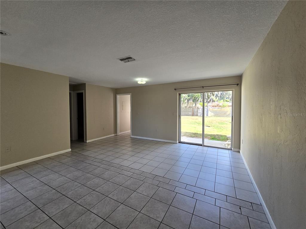 4634 Dail Road Lakeland, FL 33813 - Photo 4 of 10 a view of an empty room with window and a kitchen
