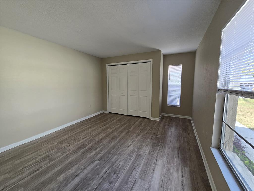 4634 Dail Road Lakeland, FL 33813 - Photo 6 of 10 an empty room with wooden floor and windows