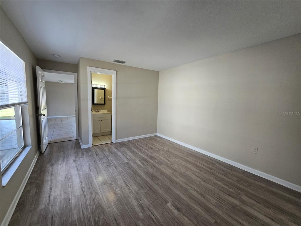 4634 Dail Road Lakeland, FL 33813 - Photo 7 of 10 wooden floor in an empty room with a window