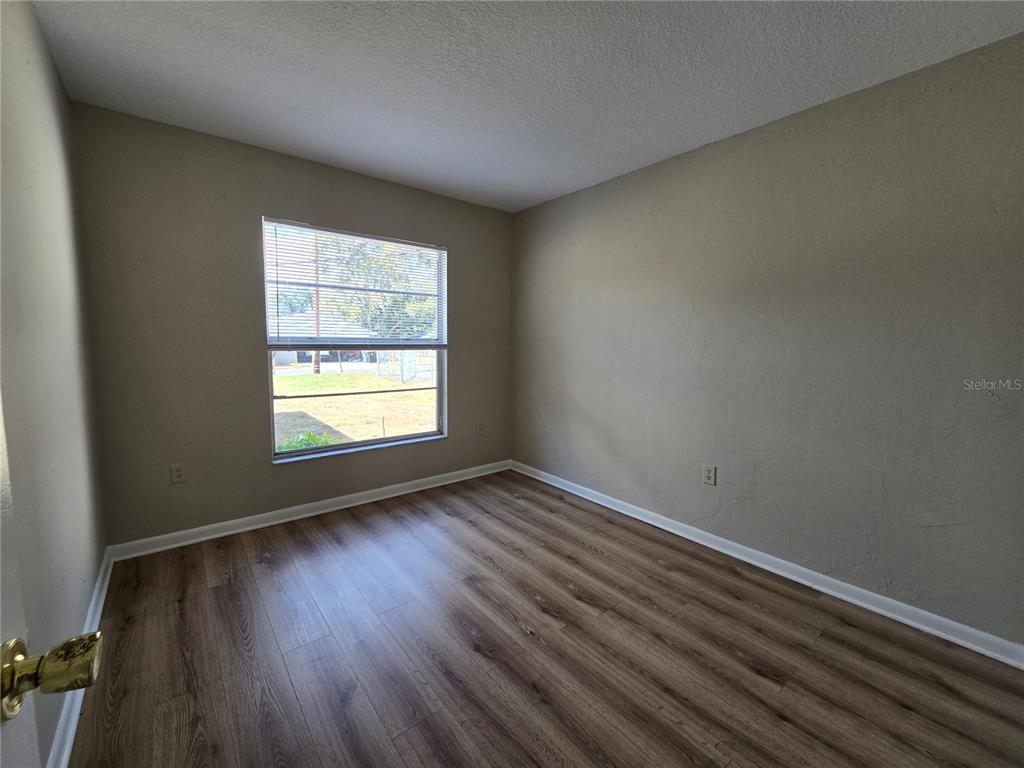 4634 Dail Road Lakeland, FL 33813 - Photo 8 of 10 an empty room with wooden floor and windows