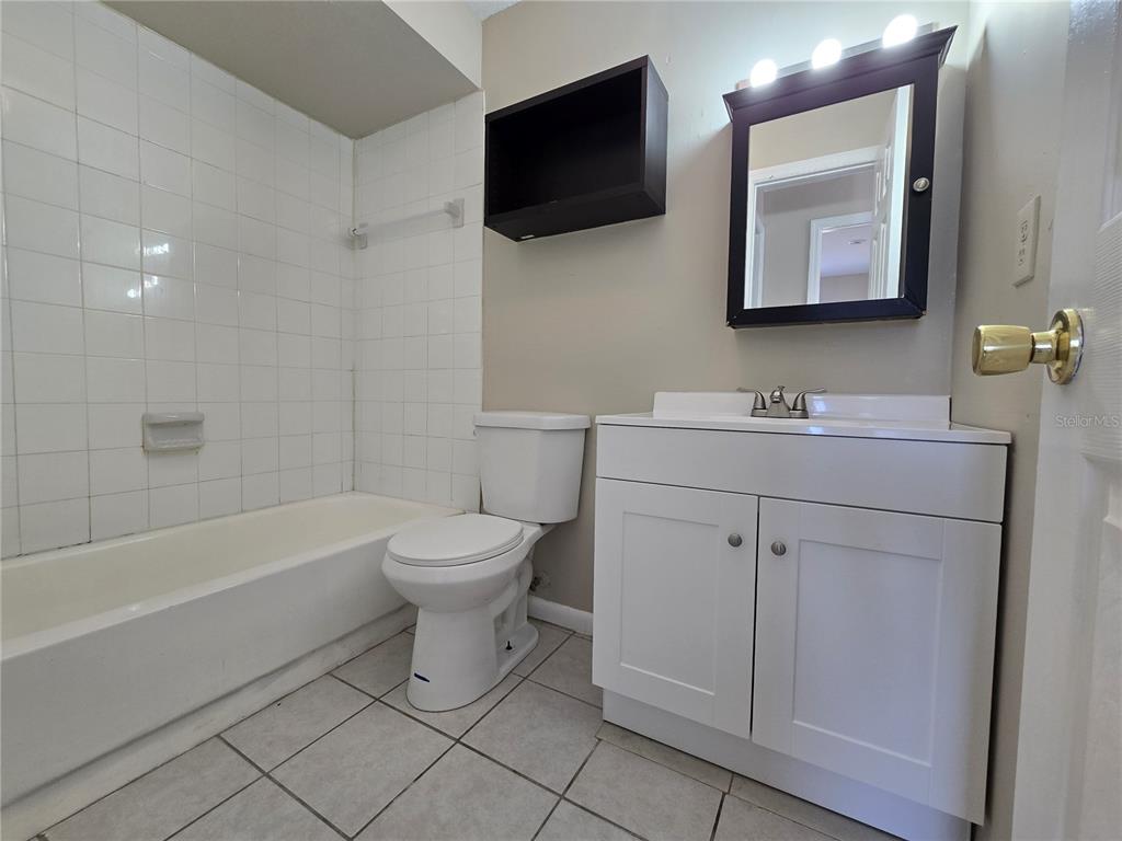 4634 Dail Road Lakeland, FL 33813 - Photo 9 of 10 a bathroom with a toilet sink and mirror