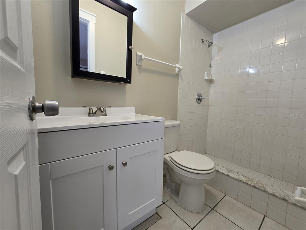 4634 Dail Road Lakeland, FL 33813 - Photo 10 of 10 a bathroom with a toilet sink and mirror