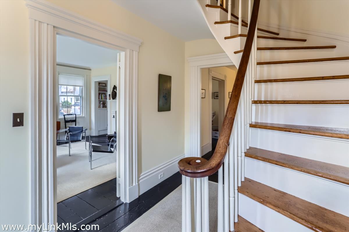 27 Spring Street Vineyard Haven, MA 02568 - Photo 19 of 58 a view of a hallway with wooden floor and staircase