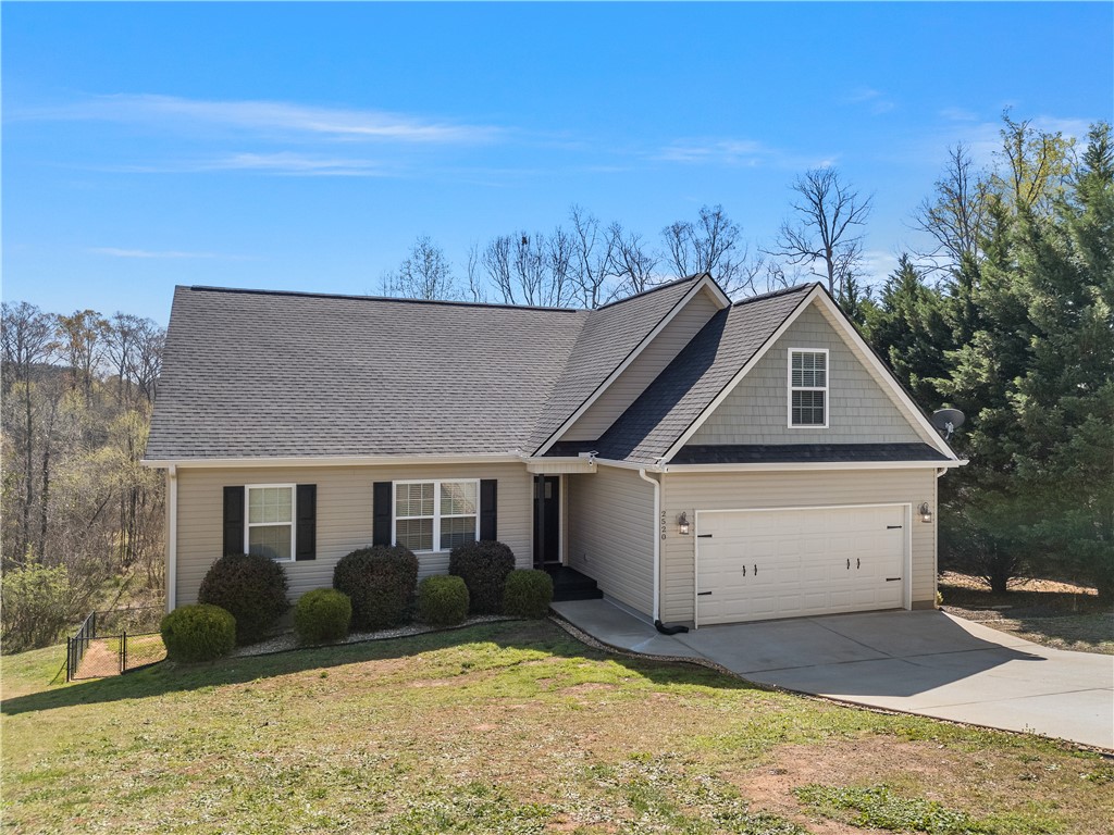 2520 Linmar Circle Anderson, SC 29621 - Photo 5 of 50 A welcoming facade with a dual garage door and ample natural surroundings beckons.