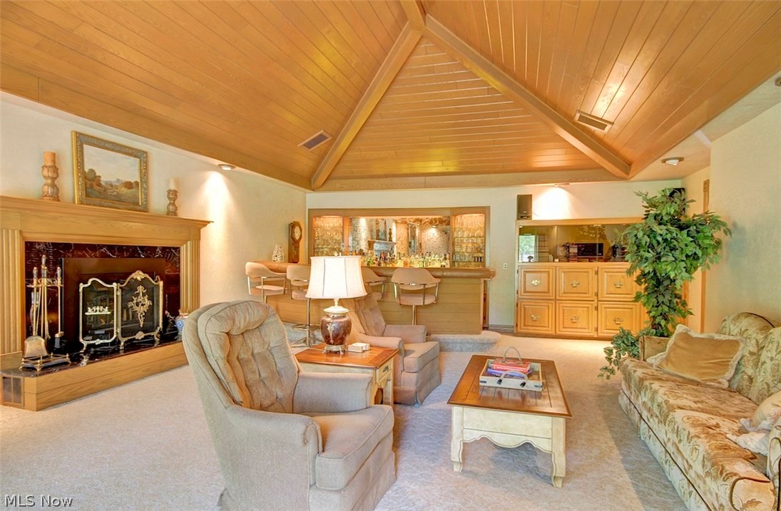 2078 Ridge Road Hinckley, OH 44233 - Photo 13 of 35 Great room w/fireplace & vaulted wood ceiling is the perfect entertaining room with a custom bar and custom built-ins throughout! There is a slider that leads to the back patio at the other end of this room that is open to the kitchen.