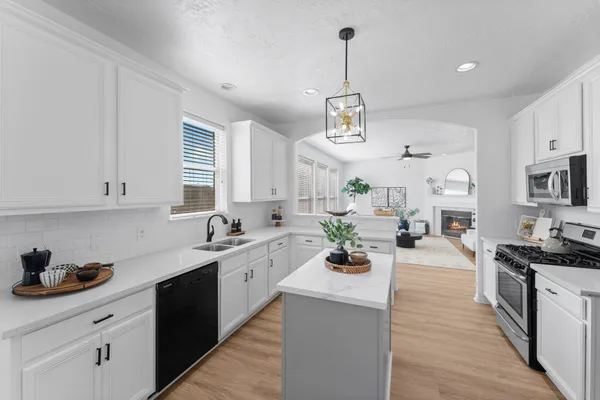 a kitchen with sink refrigerator and stove