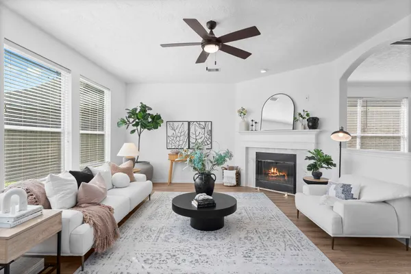 a living room with furniture and a chandelier