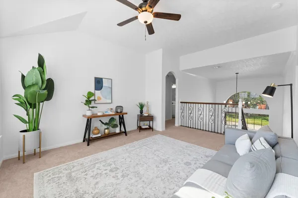 a bedroom with a bed and a table in it with window
