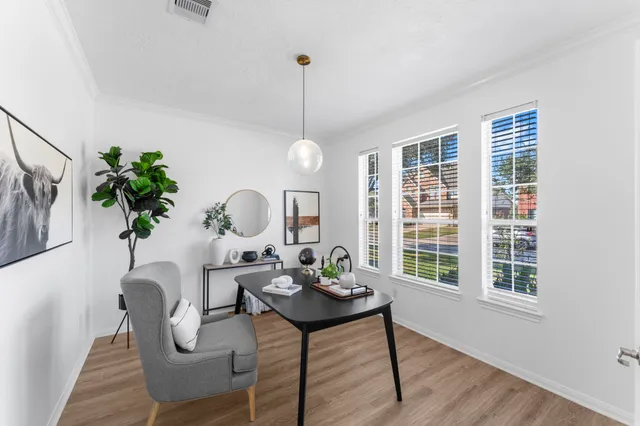 a view of a dining room with furniture window and wooden floor