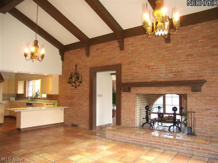 1630 County Line Road Gates Mills, OH 44040 - Photo 7 of 24 The 25 by 17 ft Dining Room adjacent to the kitchen has space for the largest of dining tables plus additional furniture groupings. The fireplace with magnificent andirons opens onto the light-filled Great Room. There's a wet bar with copper sink and closed storage on the opposite wall, plus sliders to the patio.