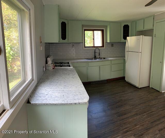 681 Main Street Great Bend, PA 18821 - Photo 9 of 22 a kitchen with a sink a refrigerator and window