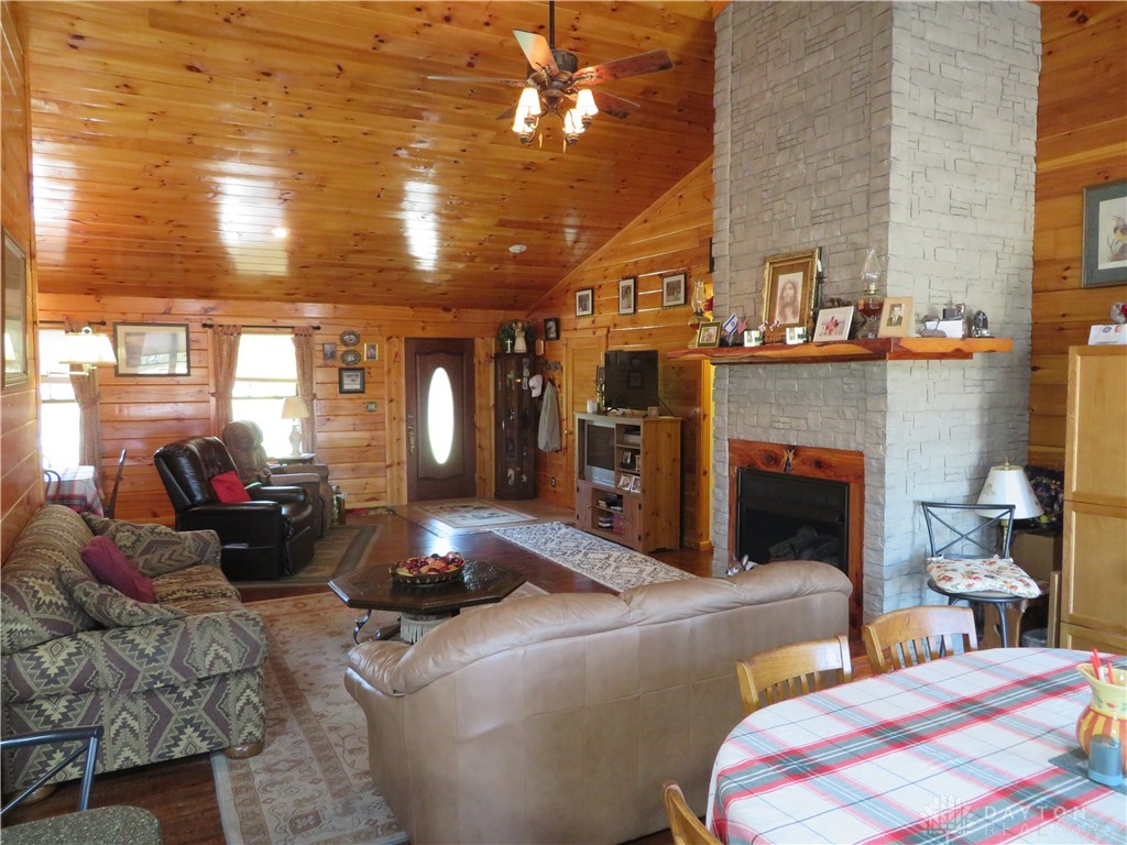 748 Inlow Avenue Peebles, OH 45660 - Photo 17 of 61 Warm wood tones and a prominent stone fireplace create an inviting living space.