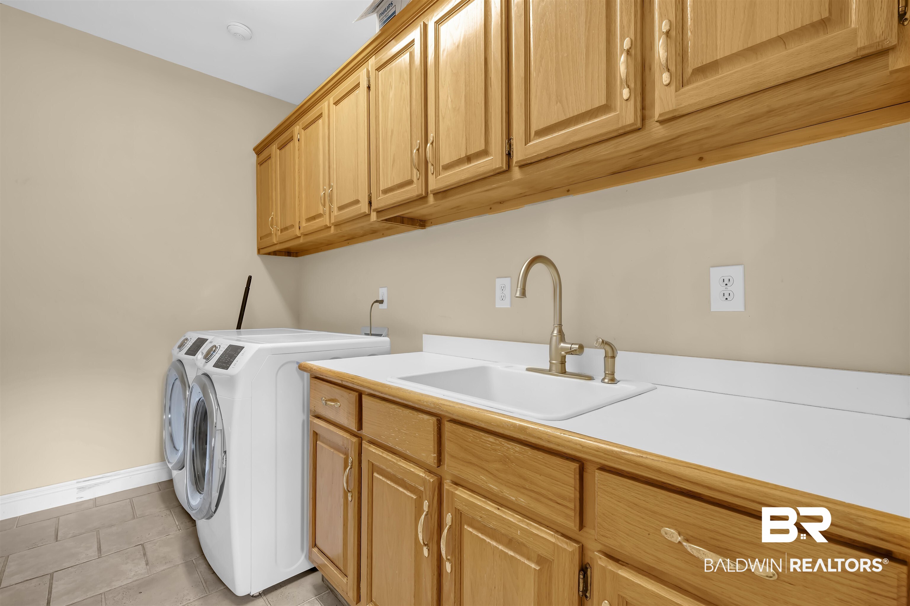 1262 Patrick Street Daphne, AL 36526 - Photo 15 of 35 Washroom featuring cabinet space, washing machine and dryer, and light tile patterned flooring