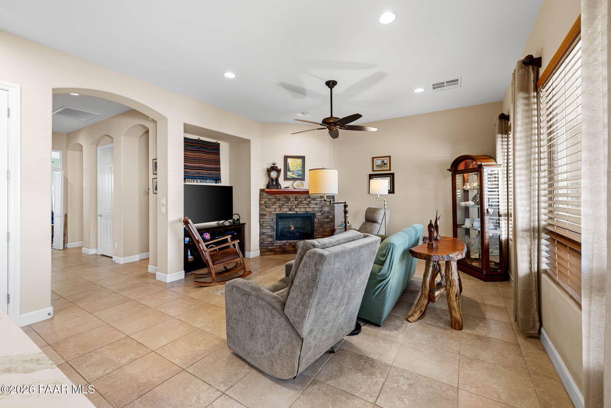 1636 Constable Street Prescott, AZ 86301 - Photo 12 of 41 a living room with furniture a fireplace and a flat screen tv