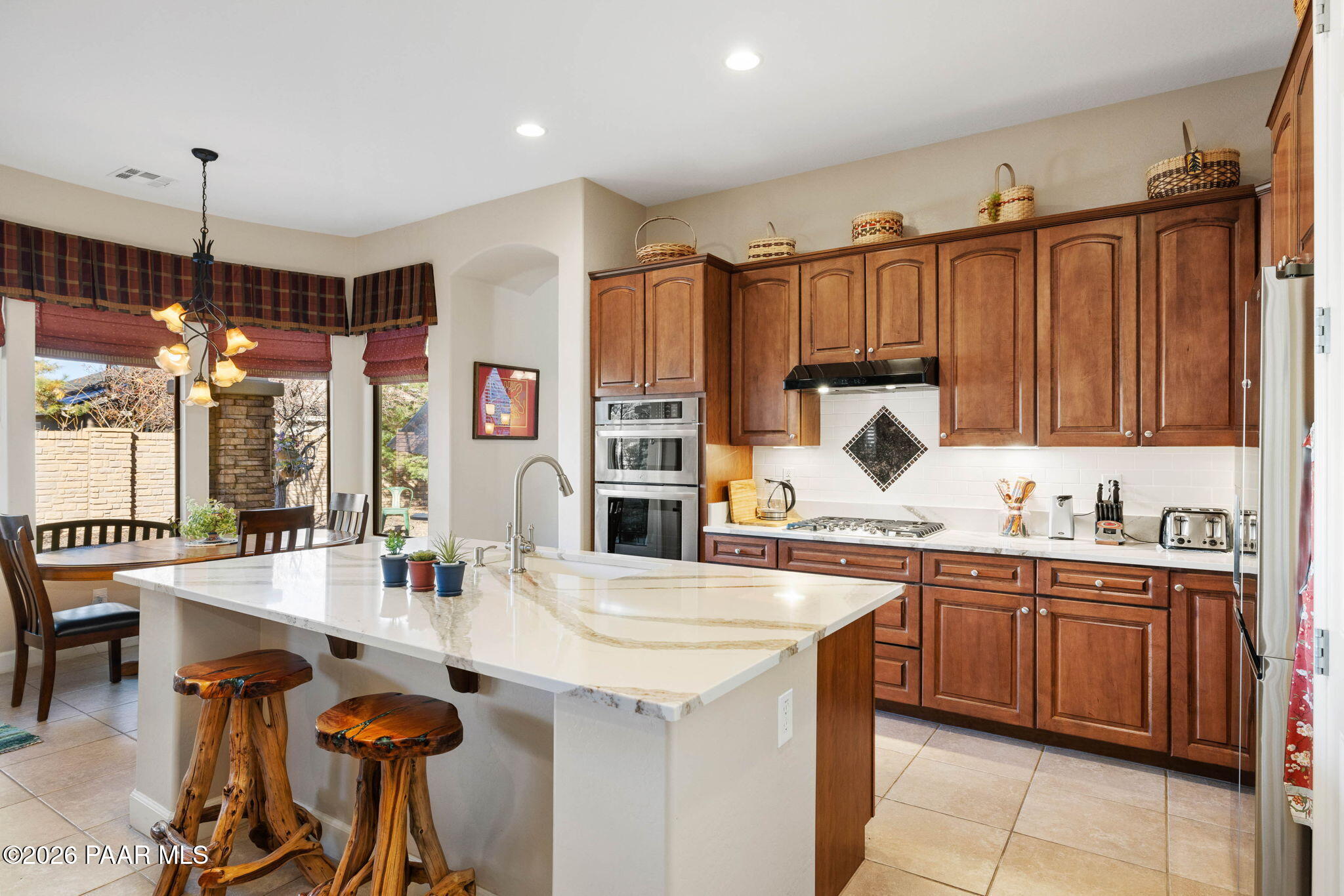 1636 Constable Street Prescott, AZ 86301 - Photo 17 of 41 a kitchen with kitchen island a sink table and chairs