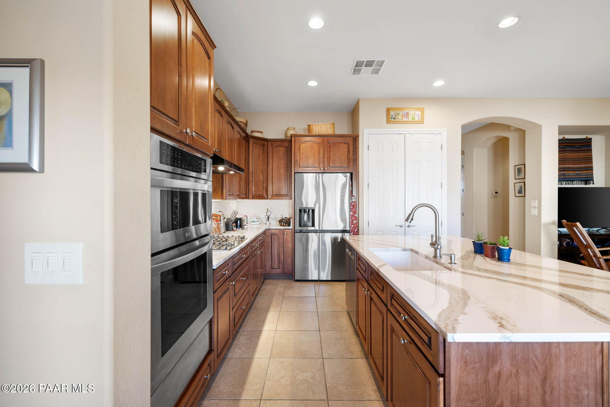 1636 Constable Street Prescott, AZ 86301 - Photo 18 of 41 a large kitchen with stainless steel appliances kitchen island granite countertop a sink and cabinets