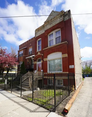 a view of a brick house with large windows
