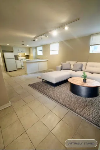 a kitchen with a sink a refrigerator and window