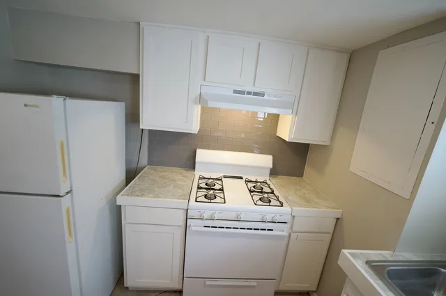 a bathroom with a sink toilet and a mirror