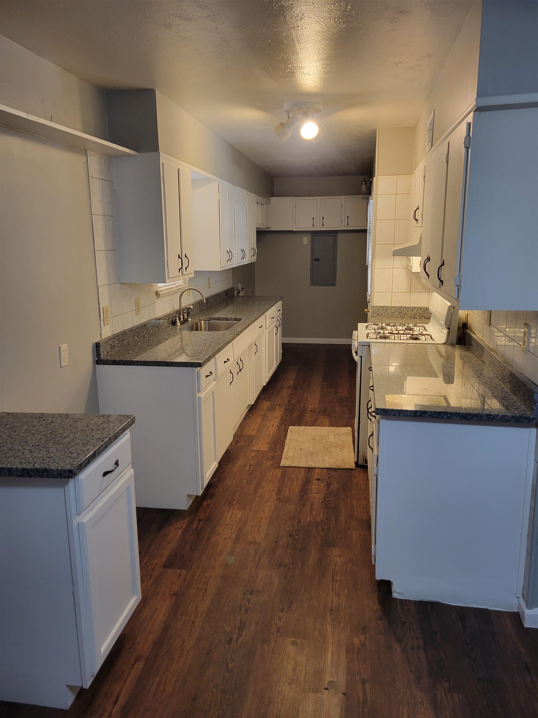 5588 Loch Lomond Road Memphis, TN 38116 - Photo 13 of 16 a kitchen with granite countertop a sink and cabinets