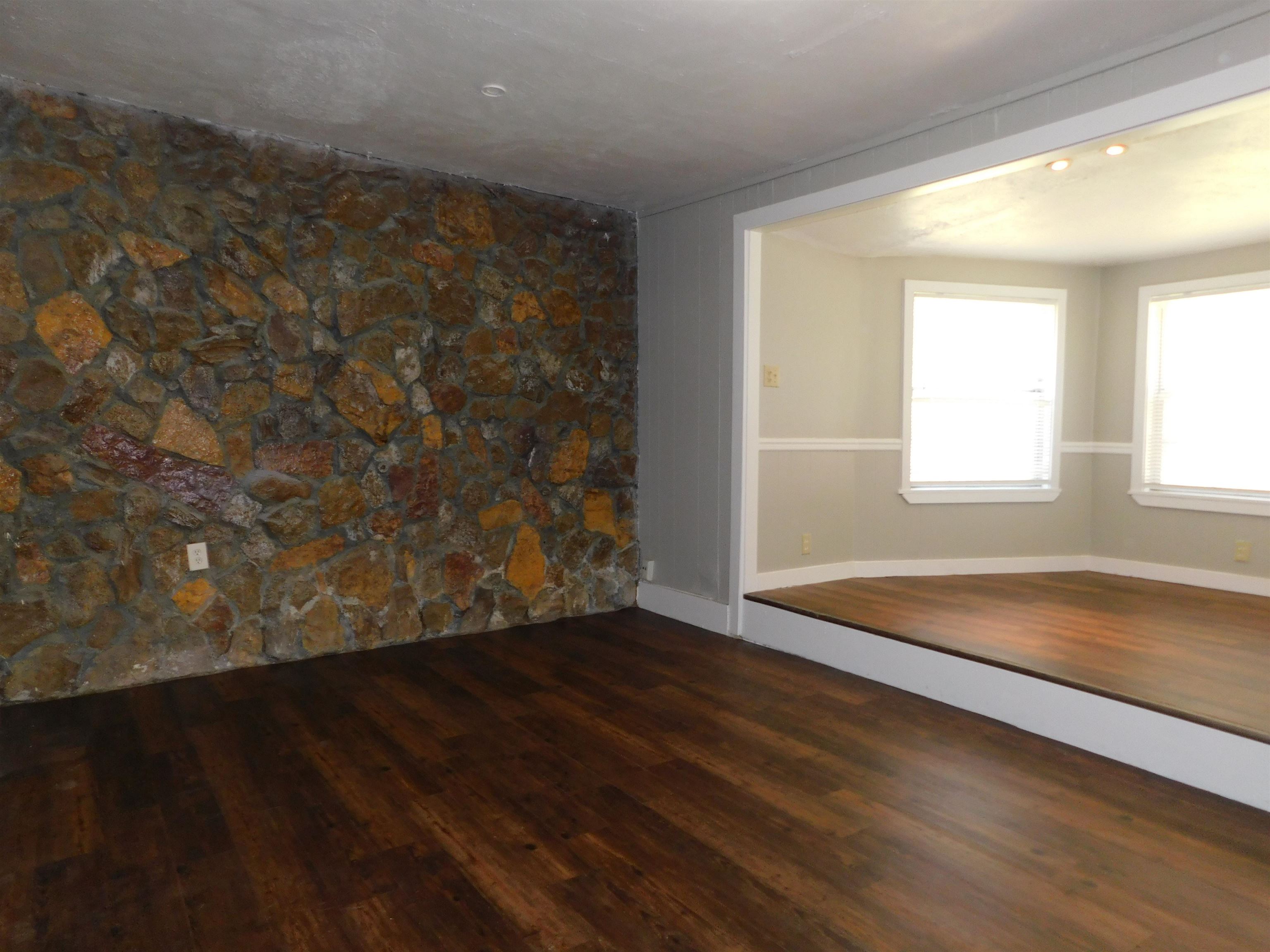 5588 Loch Lomond Road Memphis, TN 38116 - Photo 16 of 16 a view of an empty room with wooden floor and a window