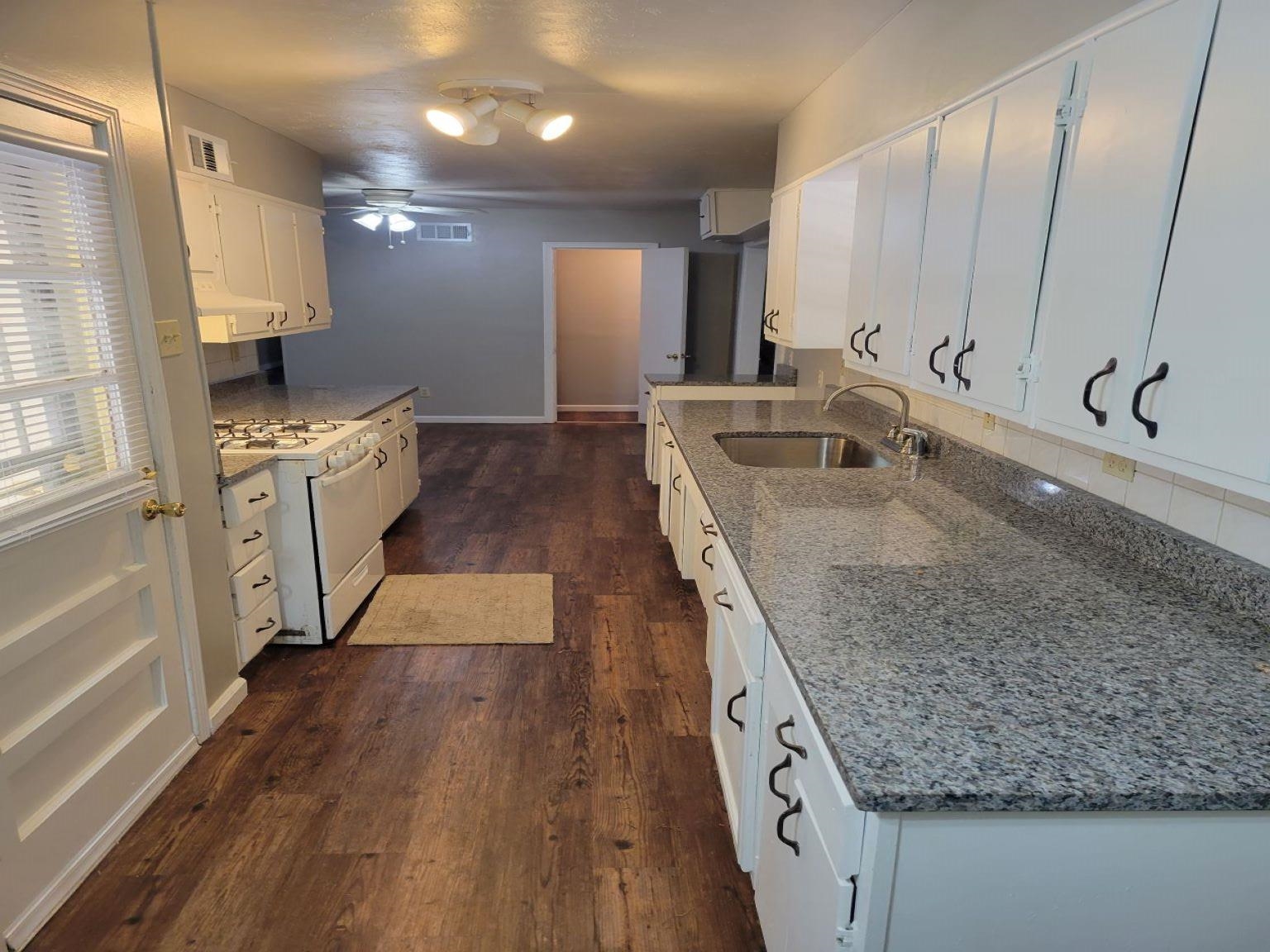 5588 Loch Lomond Road Memphis, TN 38116 - Photo 3 of 16 a large kitchen with kitchen island a large counter space a sink a stove and a refrigerator