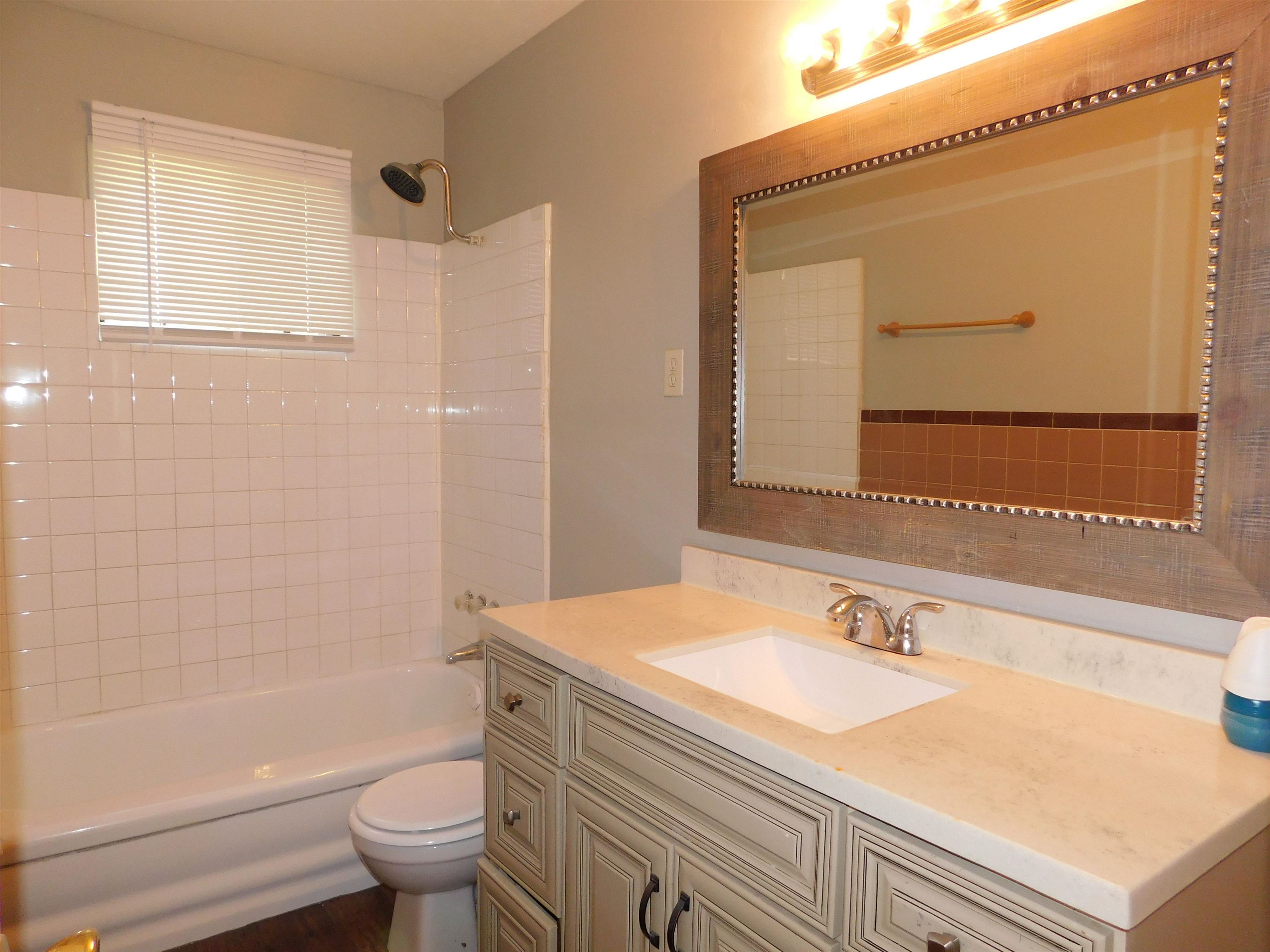 5588 Loch Lomond Road Memphis, TN 38116 - Photo 4 of 16 a bathroom with a sink and a mirror