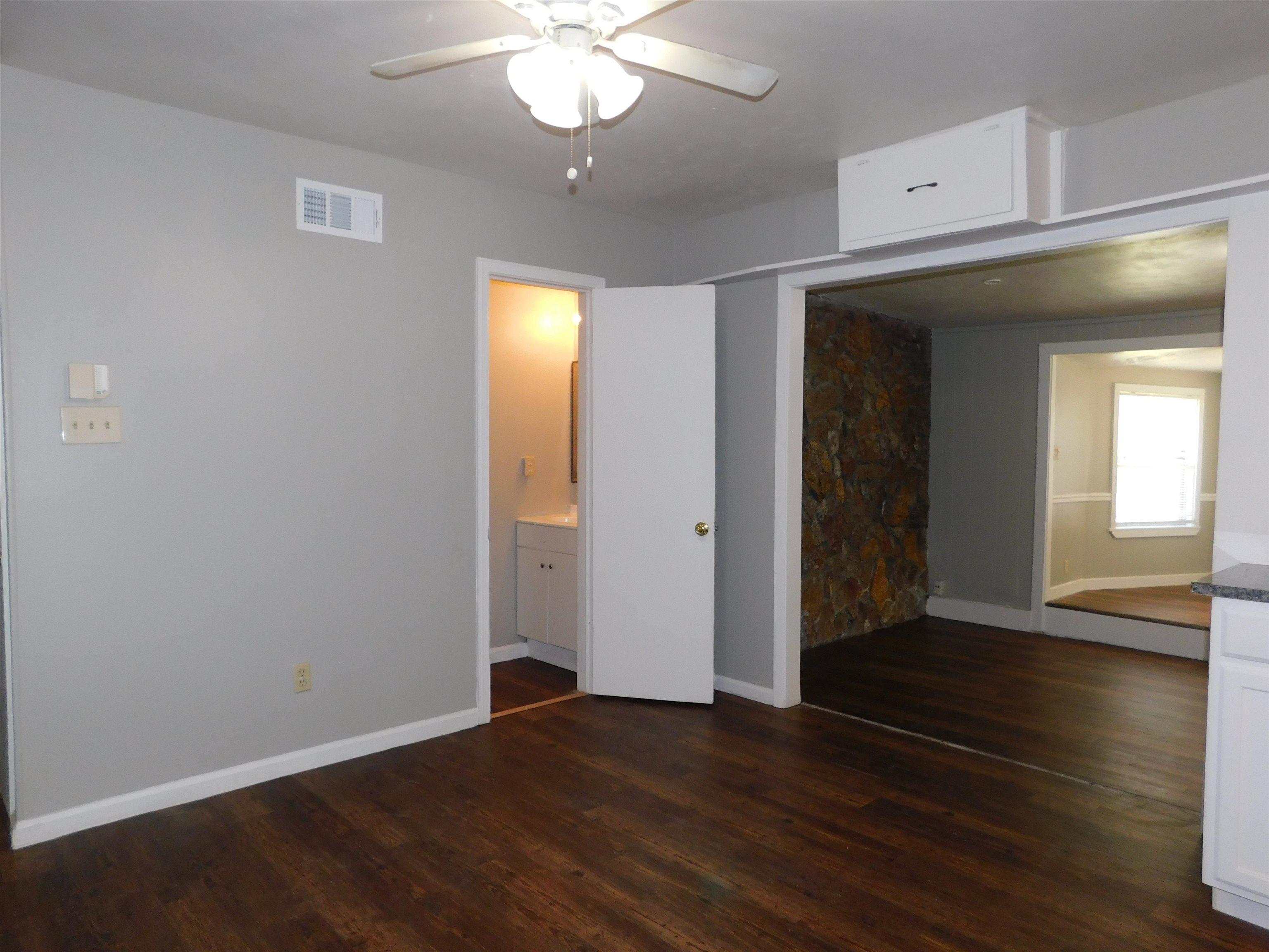 5588 Loch Lomond Road Memphis, TN 38116 - Photo 5 of 16 an empty room with wooden floor closet and windows