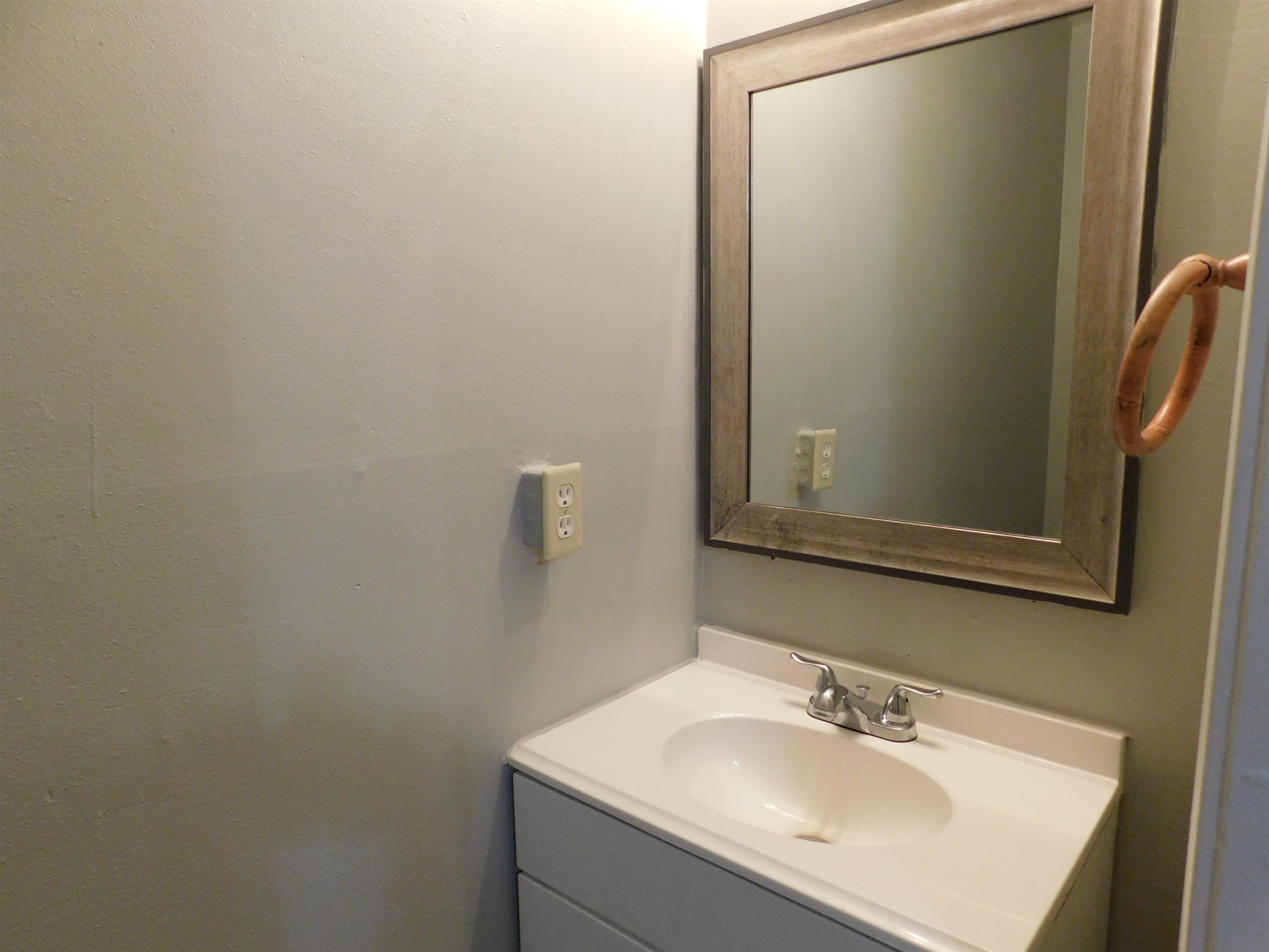5588 Loch Lomond Road Memphis, TN 38116 - Photo 7 of 16 a bathroom with a sink and mirror