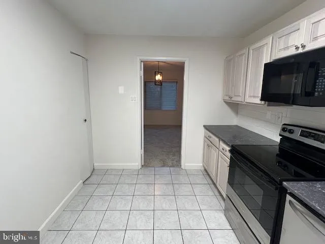 a kitchen with stainless steel appliances a sink and a stove