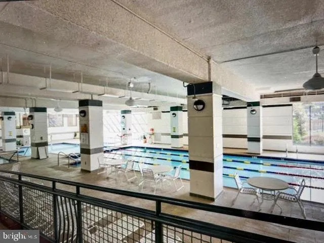 a kitchen with stainless steel appliances kitchen island granite countertop a table and chairs in it