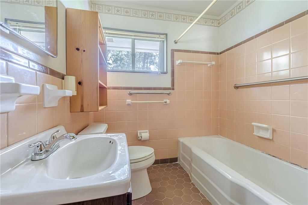 1502 North Druid Hills Road Brookhaven, GA 30319 - Photo 23 of 46 a bathroom with a sink a toilet and shower