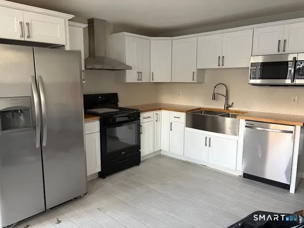 a kitchen with cabinets and stainless steel appliances