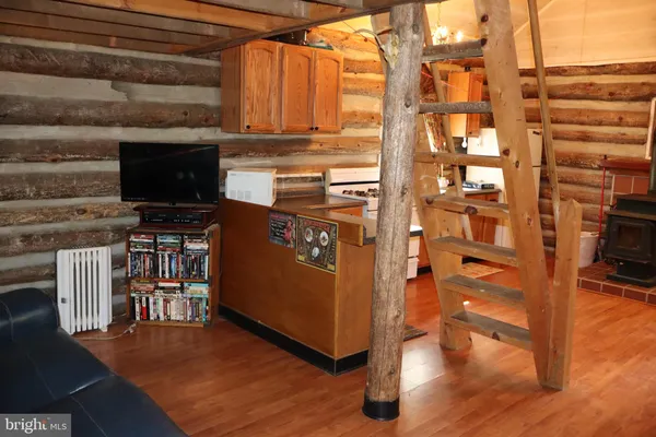 a view of a kitchen with furniture and wooden floor