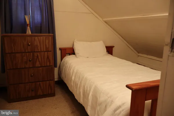 a bed sitting in a bedroom next to a window