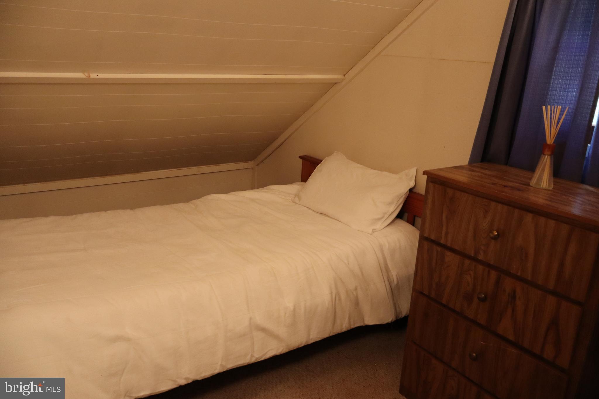 418 R R & R Ridge Road Brandywine, WV 26802 - Photo 19 of 43 a bed sitting in a bedroom next to a window