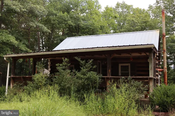 a view of a house with backyard and trees