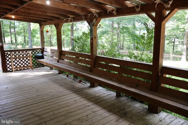 a view of a wooden deck with a yard