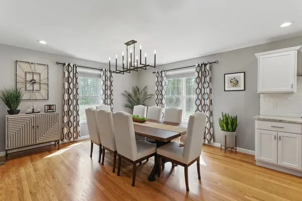 a large kitchen with a table and chairs