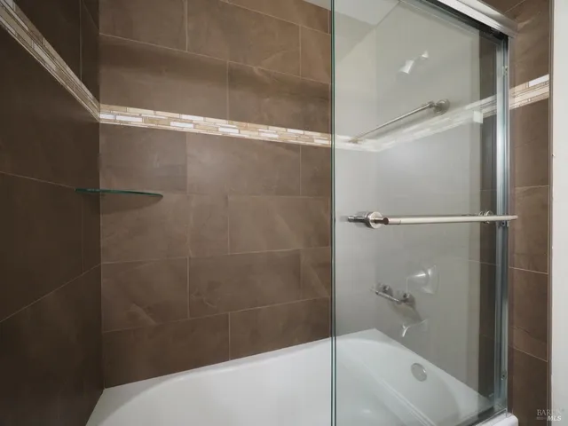 a bathroom with a bathtub and a shower