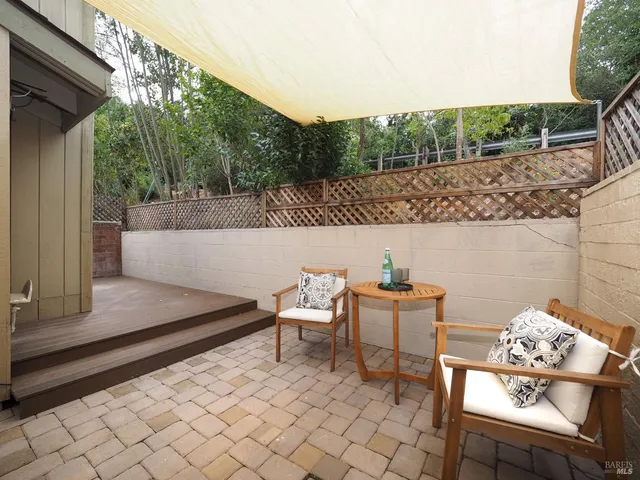 a roof deck with table and chairs